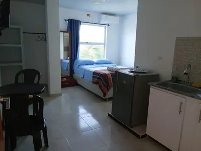 a small bedroom with a bed and a window at Cabaña Villa Carmen in Juan de Acosta