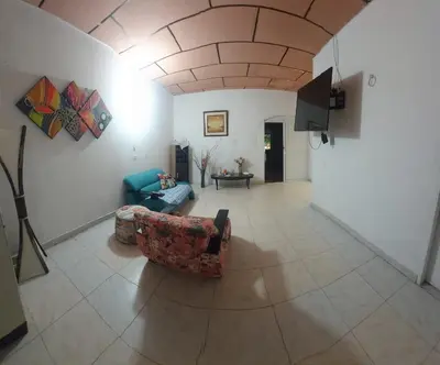 a living room with a couch and a tv at Casa ITCI Tours in Cartagena de Indias