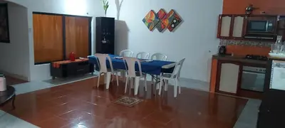 a dining room with a blue table and white chairs at Casa ITCI Tours in Cartagena de Indias