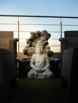a statue of a buddha sitting on the ground at Suite con balcón cerca al centro Cartagena in Cartagena de Indias