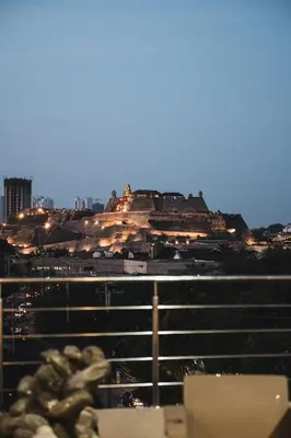 a view of a building on a hill at night at Suite con balcón cerca al centro Cartagena in Cartagena de Indias