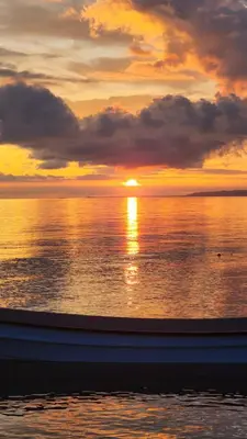 a sunset over the ocean with the sun setting at El Embrujo Tintipan in Tintipan Island