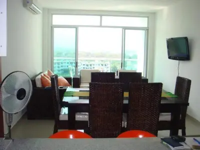 a dining room with a table and chairs and a window at Costazul Suites 705 in Santa Marta