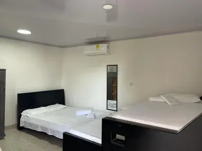 two beds in a room with white walls at sophia house in Cartagena de Indias