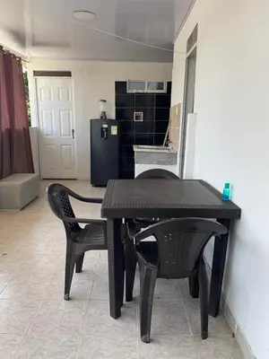 a black table and chairs in a room with a kitchen at sophia house in Cartagena de Indias