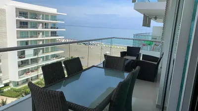 a balcony with a table and chairs and the beach at MORROS ULTRA APTO 706 in Cartagena de Indias