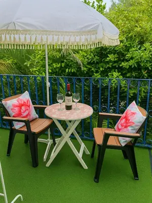 a table and two chairs with a table and an umbrella at Casa MIKONOS in Cartagena de Indias