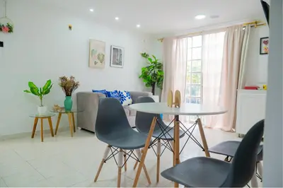 a living room with a table and chairs and a couch at Casa MIKONOS in Cartagena de Indias