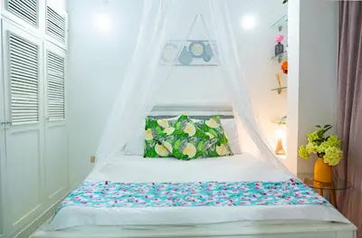 a bed with a canopy in a room at Casa MIKONOS in Cartagena de Indias