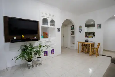 a living room with a flat screen tv on a wall at Casa MIKONOS in Cartagena de Indias