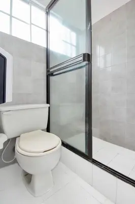 a bathroom with a toilet and a shower at Kpré Coveñas by Bernalo Hotels in Coveñas