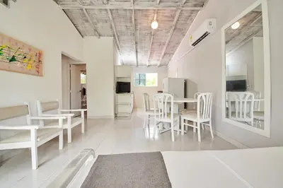 a living room with white chairs and a table at Kpré Coveñas by Bernalo Hotels in Coveñas