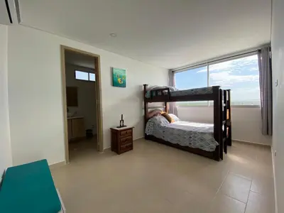 a bedroom with two bunk beds and a window at Magico Apartamento Frente al Mar 3 Habitaciones FB73 in Coveñas