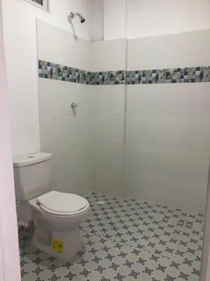 a bathroom with a white toilet and a shower at Manglearena in Tolú