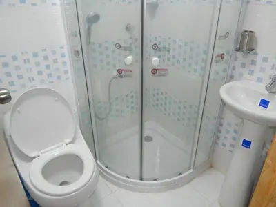 a bathroom with a shower and a toilet and a sink at Delfin 207 in Cartagena de Indias