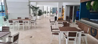 a restaurant with wooden tables and chairs in a room at Palmetto frente al mar 2603 in Cartagena de Indias