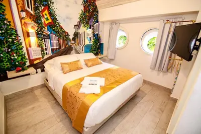 a bedroom with a bed and a christmas tree at Hotel Boutique Callecitas de San Diego in Cartagena de Indias