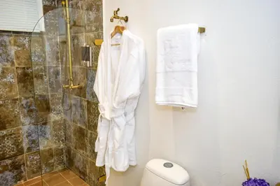 a bathroom with a shower and white towels at Hotel Boutique Callecitas de San Diego in Cartagena de Indias
