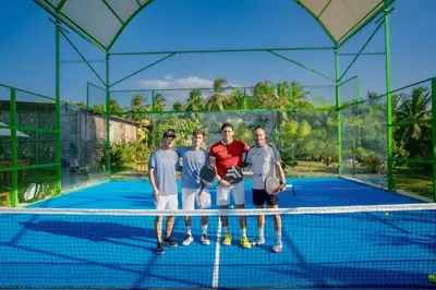 a group of four men standing on a tennis court at Vista Mare Beach House in Tierra Bomba