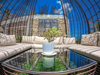 a living room with a couch and a glass table at Vista Mare Beach House in Tierra Bomba
