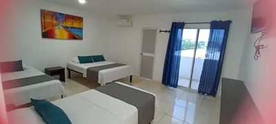 a small room with two beds and a window at Hotel La Inmaculada in Soledad
