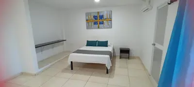 a white room with a bed and a bench at Hotel La Inmaculada in Soledad