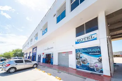 a building with a car parked in front of it at Hotel La Inmaculada in Soledad