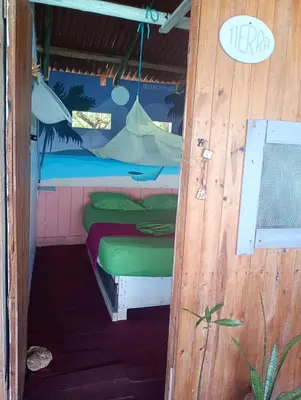 a small room with a bed in a house at DespertArte espacio de Arte y Hospedaje in Playa Blanca