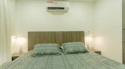 a bedroom with a bed with two pillows at APARTAMENTO MARINARE DE 2 HABITACIONES CON SALIDA DIRECTA A LA PLAYA in Cartagena de Indias