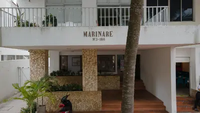 a dog sitting in front of a building at APARTESTUDIO MARINARE DE 1 HABITACION CON SALIDA DIRECTA A LA PLAYA m in Cartagena de Indias