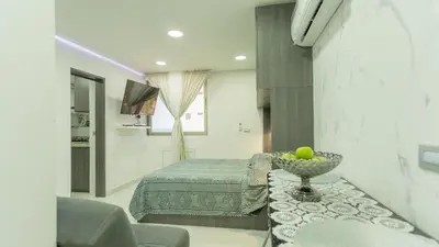a bedroom with a bed and a bowl of fruit on a table at APARTESTUDIO MARINARE DE 1 HABITACION CON SALIDA DIRECTA A LA PLAYA m in Cartagena de Indias