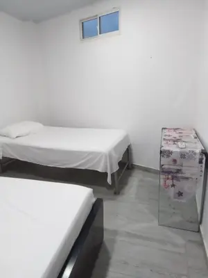 a room with two beds and a table in it at Casa Hotel Alborada in San Antero