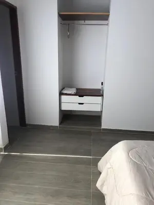 a bedroom with white walls and a bed in a room at Casa Hotel Alborada in San Antero