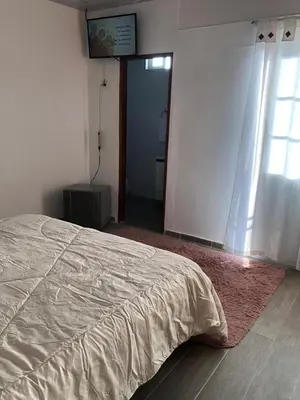 a bedroom with a bed and a door with a window at Casa Hotel Alborada in San Antero