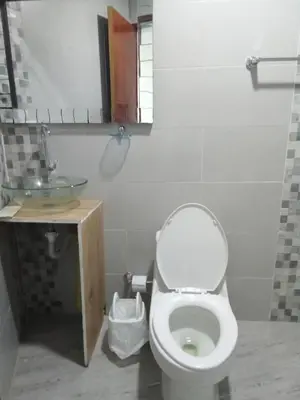 a bathroom with a toilet and a sink at Casa Hotel Alborada in San Antero