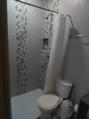 a bathroom with a toilet and a shower at Casa Hotel Alborada in San Antero