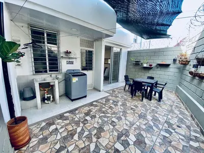 a patio with a table and chairs and a fireplace at La palma- casa amoblada Palma Mayorca in Sincelejo