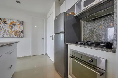 a kitchen with a stainless steel stove and refrigerator at Morros Pelican Sunrise - Livin Colombia in Cartagena de Indias