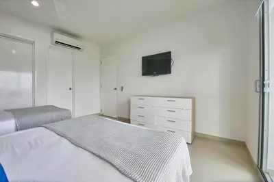 a bedroom with a bed and a tv on the wall at Morros Pelican Sunrise - Livin Colombia in Cartagena de Indias