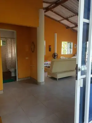a room with a couch and a bed in it at Cabaña cerca al mar - A 200 mts in Coveñas