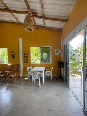 a room with a table and chairs and a yellow wall at Cabaña cerca al mar - A 200 mts in Coveñas