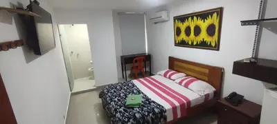 a small bedroom with a bed and a mirror at hotel interamericano in Barranquilla