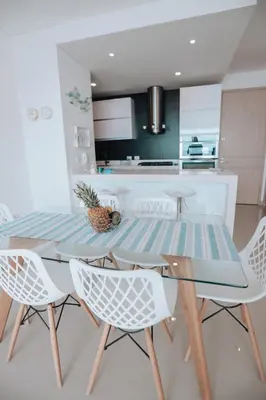 a dining room with a blue table and chairs at Deluxe Spectacular Sunset in Santa Marta