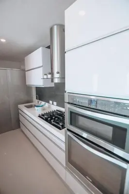 a kitchen with a stove and white cabinets at Deluxe Spectacular Sunset in Santa Marta