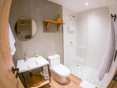 a bathroom with a white toilet and a sink at Mosaic Studios Buenavista in Barranquilla