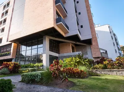 a building with windows and plants in front of it at Mosaic Studios Buenavista in Barranquilla