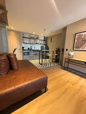 a living room with a couch and a kitchen at Mosaic Studios Buenavista in Barranquilla