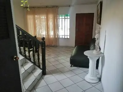 a room with a staircase and a chair and a table at Hospedaje Altamira in Barranquilla