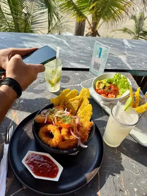 a table with a plate of food on a table at Hotel Coco Beach by Croma in Cartagena de Indias