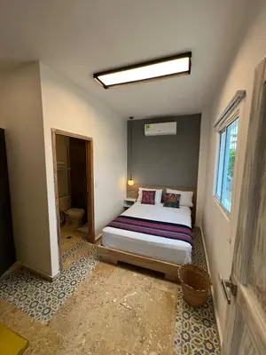 a bedroom with a bed in a room with a window at Hotel Coco Beach by Croma in Cartagena de Indias